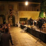 El concert començava al Palau Comtal de Cocentaina amb "Fanfàrria de Llúria", la primera de les quatre estrenes de la nit. Aquesta peça pertany al director i compositor contestà Francisco Valor Llorens, i està basada en la marxa "Cavallers de Llúria", del mateix autor. Gabri Francés, integrant de la colla, demostrà la seua destresa recitant un apassionat poema inclòs a la composició. Tot seguit, es presentà com a nou membre del Mal Passet a Àlvaro Sellés Jordà, percussionista que entrarà a formar part de la colla. La Colla Mal Passet enceta els Moros i Cristians de Cocentaina amb el XII Concert de Festes
